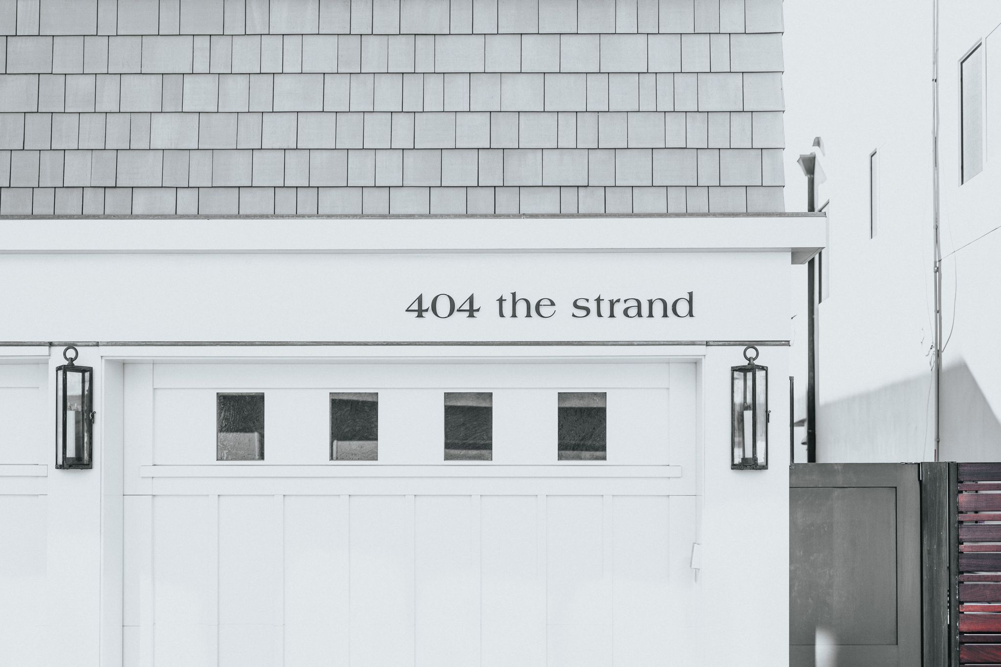 A house garage with the stree number and label '404 the strand'.