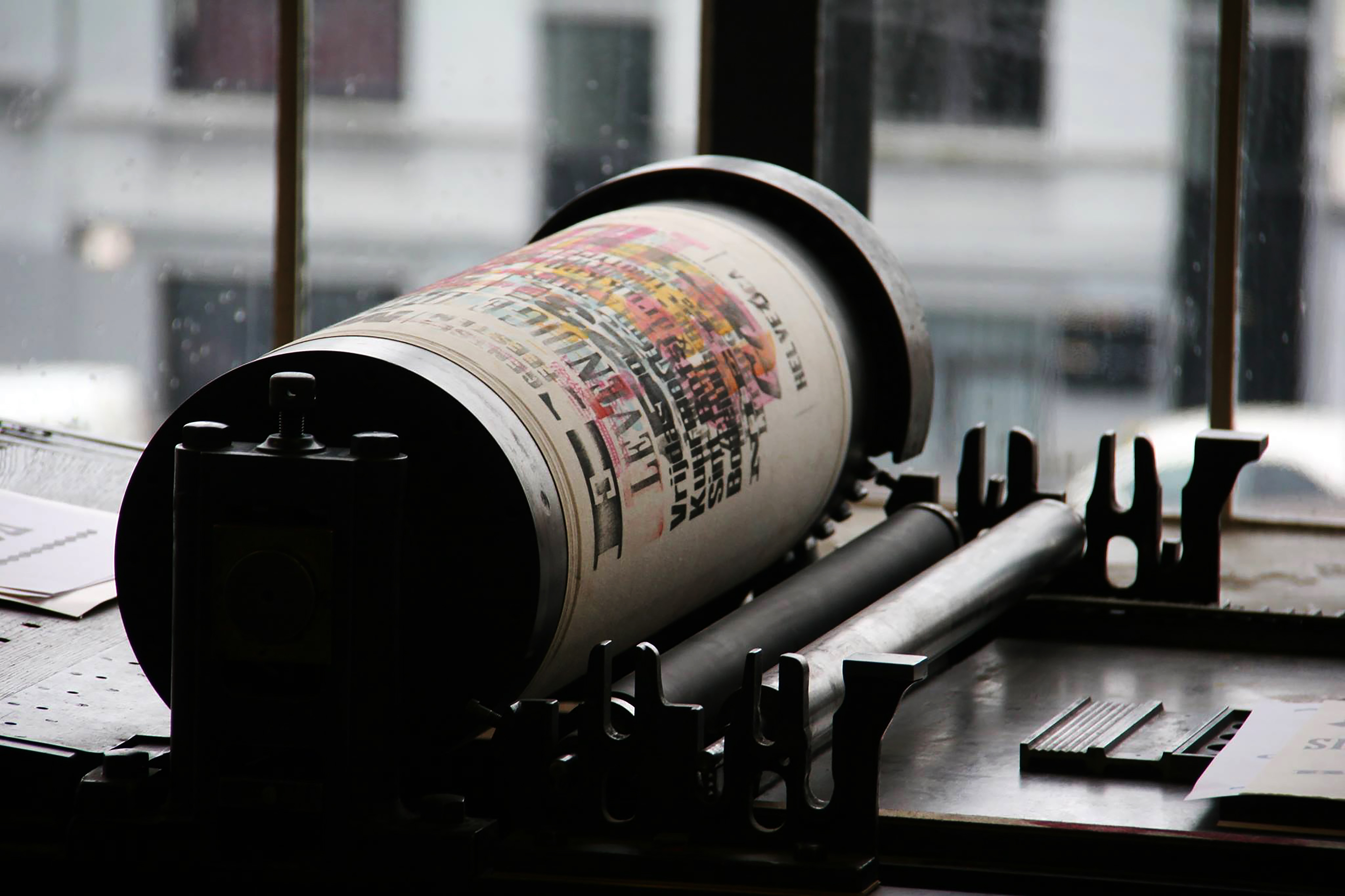 An old color printing machine, transferring a color image to paper.