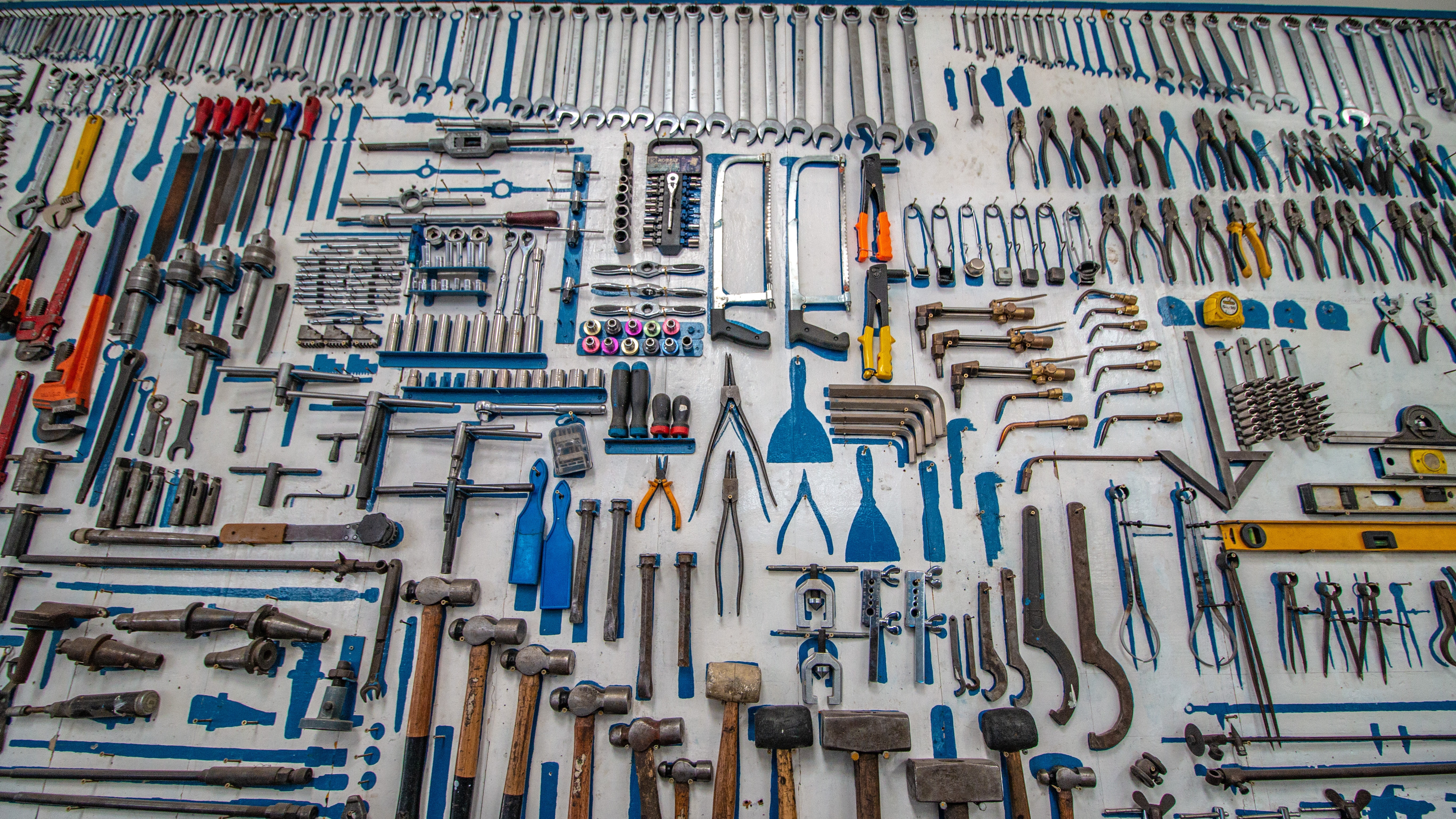 A picture of many tools on a white surface.