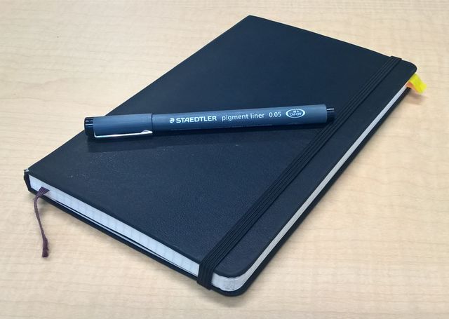 Moleskine notebook with pen