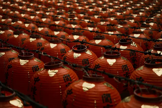 Rows of identical lanterns hanging from cords.