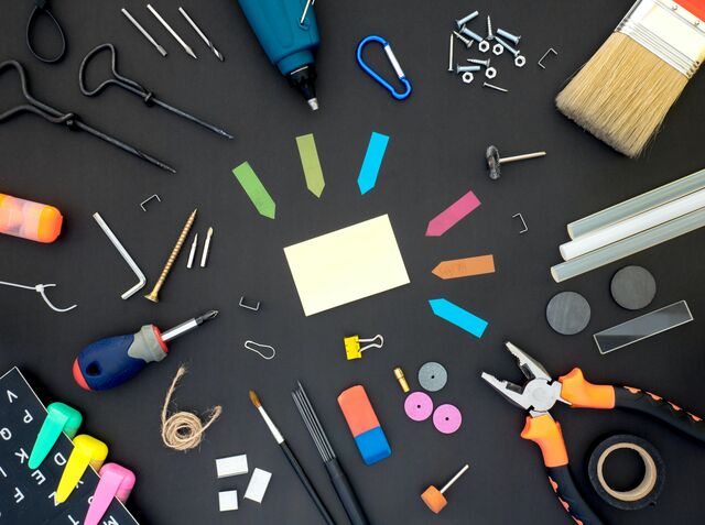 Several office tools arranged around paper and paper flags.